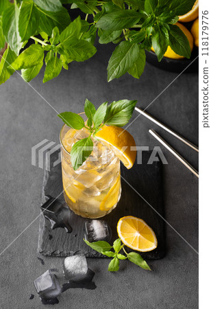 Lemonade drink with fresh lemon, lime, mint and ice. Refreshing citrus mojito cocktail Lemonade drink with fresh lemon, lime, mint and ice. Refreshing citrus mojito cocktail 118179776