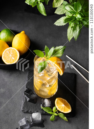 Lemonade drink with fresh lemon, lime, mint and ice. Refreshing citrus mojito cocktail  118180040