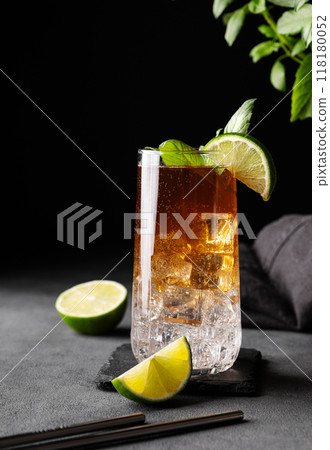 Coffee brew with tonic, ice and lime in a tall glass on a dark background with citrus fruit and herb Coffee brew with tonic, ice and lime in a tall glass on a dark background with citrus fruit and herb 118180052