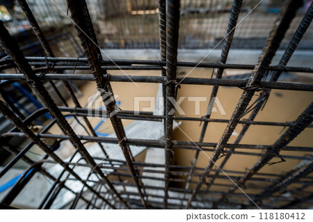 A construction site displaying a reinforced concrete foundation with steel rebar 118180412