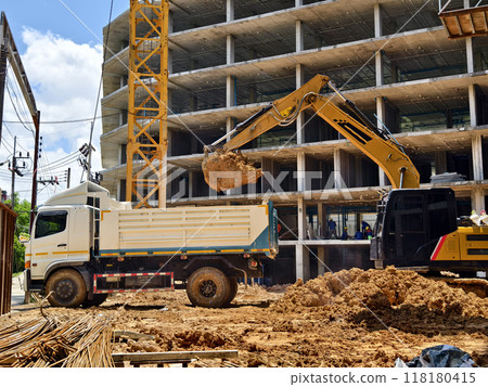 Excavator loads ground into a dump truck at a construction site 118180415