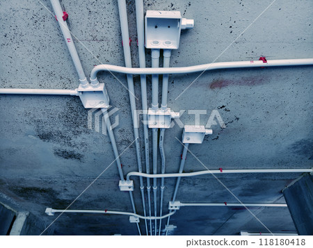 The electrical wiring at the construction site is completed and suspended from the ceiling The electrical wiring at the construction site is completed and suspended from the ceiling 118180418