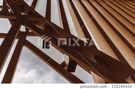 A structure featuring wooden slats on construction site contributing to its architectural style 118180420