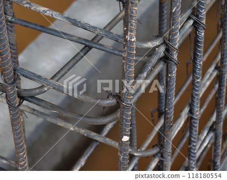 A construction site displaying a reinforced concrete foundation with steel rebar 118180554