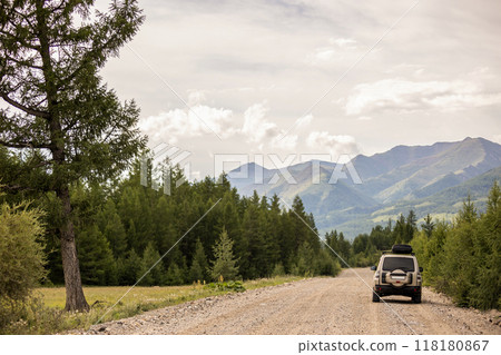 SUV on scenic mountain road in the forest 118180867
