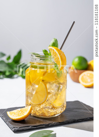 Lemonade drink or cold tea with fresh lemon, mint and ice in jar. Refreshing citrus mojito cocktail 118181108