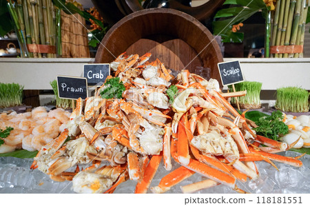 Superbly cooked fresh seafood cold station at International Buffet Restaurant. Prawn, Crab and Scallop on ice decorated with wooden bucket Superbly cooked fresh seafood cold station at International Buffet Restaurant. Prawn, Crab and Scallop on ice decorated with wooden bucket 118181551