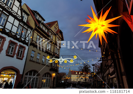 Charming Wernigerode town evening street view illuminated with Christmas lights garlands Herrnhutter stars on historical half-timbered houses facade. Twilight Festive city in Germany Charming Wernigerode town evening street view illuminated with Christmas lights garlands Herrnhutter stars on historical half-timbered houses facade. Twilight Festive city in Germany 118181714