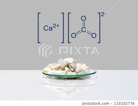 Calcium carbonate chip in chemical watch glass with molecular structure on white laboratory table. Side view Calcium carbonate chip in chemical watch glass with molecular structure on white laboratory table. Side view 118182736