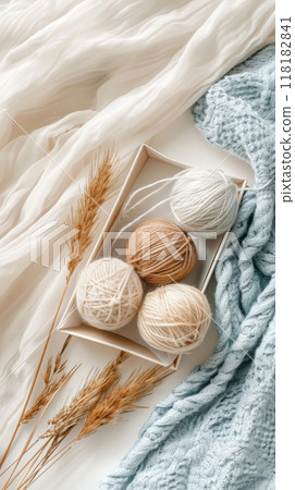 Neutral Yarn Balls with Pampas Grass on Fabric 118182841