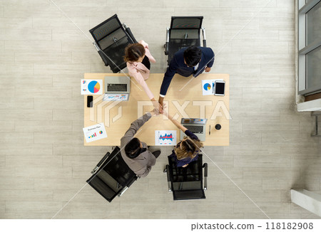 Business partner join hand in the modern office. Business executive team meeting business plan in modern office with laptop computer, tablet, mobile phone and document on table. Top view Business partner join hand in the modern office. Business executive team meeting business plan in modern office with laptop computer, tablet, mobile phone and document on table. Top view 118182908