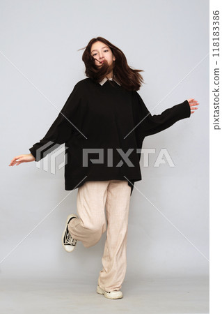 Girl in a black hoodie stands poised, the front clear for prints. Use this as a mockup for your logo or artwork. Girl in a black hoodie stands poised, the front clear for prints. Use this as a mockup for your logo or artwork. 118183386