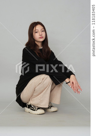 Teen in a plain top, her subdued demeanor highlighting the emotional depth and contemplative moments of teenage years. Teen in a plain top, her subdued demeanor highlighting the emotional depth and contemplative moments of teenage years. 118183405