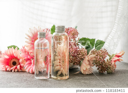 Lace curtains, pink flowers and plastic bottles 118183411