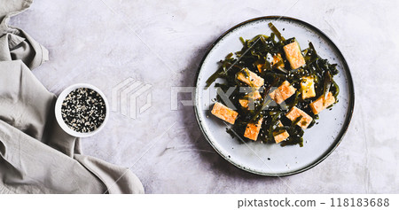 Seaweed salad with fried soy tofu cheese on plate on table top view web banner Seaweed salad with fried soy tofu cheese on plate on table top view web banner 118183688