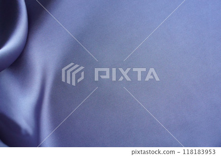 Violet silk fabric background with soft folds and space for text on smooth monochrome surface. Plain, silken, shiny textile material with shades in the folds as a template for design. 118183953