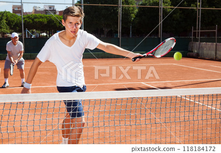 Grandfather and grandson playing tennis court 118184172