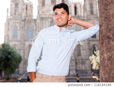 Smiling young guy on city street Smiling young guy on city street 118184186