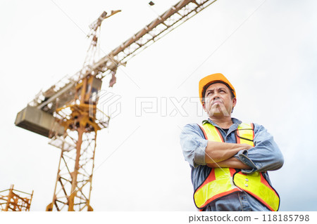 Careless worker at construction site without wearing helmet. Careless worker at construction site without wearing helmet. 118185798