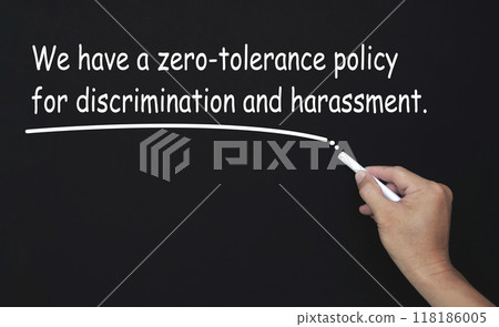 We have a zero tolerance policy for discrimination and harassment text written on blackboard. Safe workplace concept We have a zero tolerance policy for discrimination and harassment text written on blackboard. Safe workplace concept 118186005