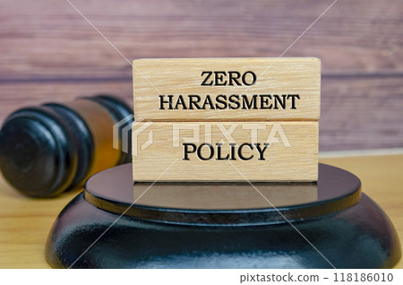 Zero Harassment Policy text written on wooden blocks with gavel background. Safe workplace concept Zero Harassment Policy text written on wooden blocks with gavel background. Safe workplace concept 118186010
