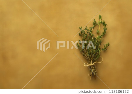 An isolated bundle of dried herbs is tied together with twine, showcasing its rustic beauty against a warm, textured background. The arrangement exudes a natural, calming essence. An isolated bundle of dried herbs is tied together with twine, showcasing its rustic beauty against a warm, textured background. The arrangement exudes a natural, calming essence. 118186122