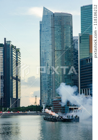 A naval cruiser firing a large artillery cannon in Singapore's M 118186212