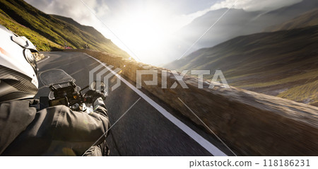 Detail of motorcycle handlebars. View from driver perspective, beautiful Alpine landscape in sunset light. 118186231