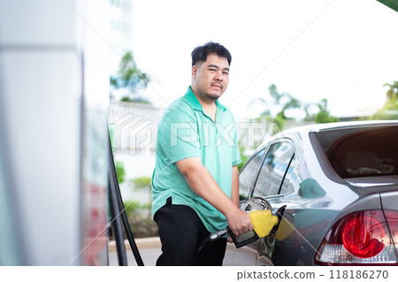 Asian man is refuels his car a gas. 118186270