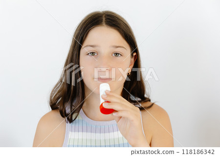 Asthma Disease. Teengirl having asthmatic attack and using inhaler preventing respiratory depression Asthma Disease. Teengirl having asthmatic attack and using inhaler preventing respiratory depression 118186342