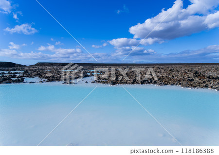 Blue Lagoon in Iceland: A Tranquil Geothermal Spa Amidst Black Lava Rocks. Blue Lagoon in Iceland: A Tranquil Geothermal Spa Amidst Black Lava Rocks. 118186388