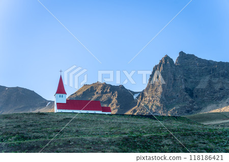 Iconic Red Church Nestled Among Icelandic Mountains. 118186421