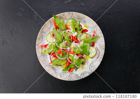Colorful fresh salad with arugula, cucumbers, and tomatoes - a perfect dish for healthy eating Colorful fresh salad with arugula, cucumbers, and tomatoes - a perfect dish for healthy eating 118187180