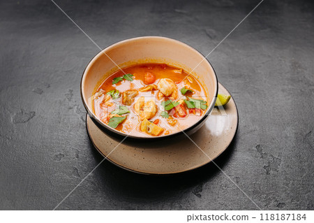 Spicy Thai Authentic Tom Yum soup with shrimp, mushrooms, and herbs, perfect for culinary projects 118187184