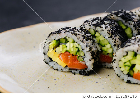 Sushi rolls with black caviar and fresh vegetables, ideal for Japanese cuisine and food photography Sushi rolls with black caviar and fresh vegetables, ideal for Japanese cuisine and food photography 118187189