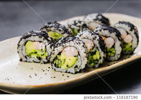 Sushi rolls with shrimp, avocado, and black caviar, perfect for Japanese cuisine and food styling 118187190