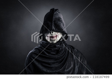 Scary figure with hooded cloak in the dark 118187499