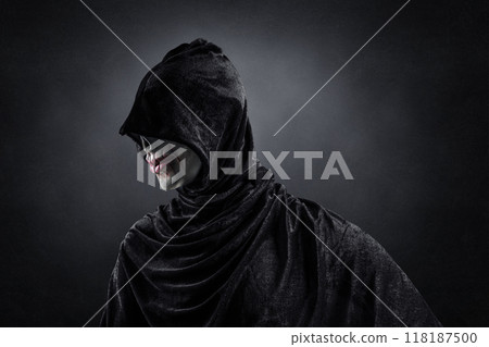 Scary figure with hooded cloak in the dark 118187500
