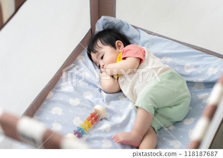 11-month-old boy sleeping in a crib 11-month-old boy sleeping in a crib 118187687