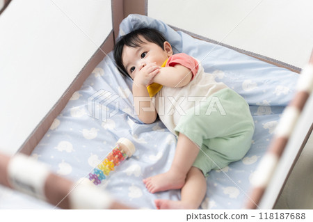 11-month-old boy sleeping in a crib 11-month-old boy sleeping in a crib 118187688