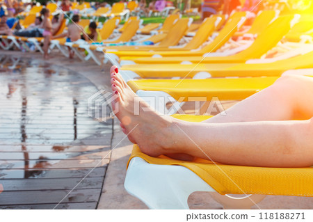 Girl lying in hammock by the pool Girl lying in hammock by the pool 118188271
