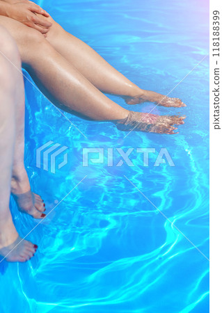 Feet getting wet in the pool water. 118188399