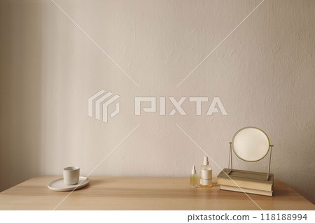 Cosmetic products and golden make up mirror on wooden table. Unrecognizable bottles mockups with blank labels. Perfume, serum and samplers. Beauty concept. Cup of tea, coffee. Skin care routine. 118188994