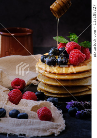 pancakes with berries and honey on dark background pancakes with berries and honey on dark background 118189227