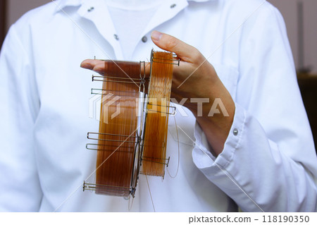 capillary column for gas chromatographic analysis. laboratory equipment for analytical chemistry. the engineer demonstrates the column 118190350
