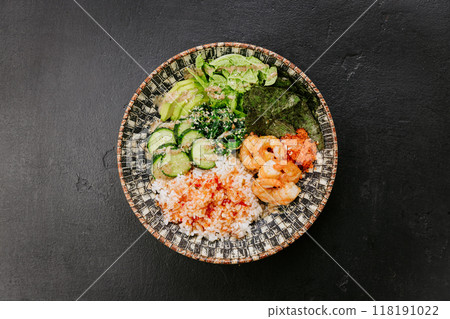 Shrimp poke bowl with rice, seaweed, avocado, and cucumber - fresh and healthy Asian-inspired dish 118191022