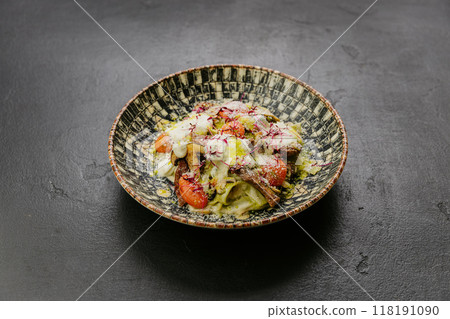 Pasta with mushrooms, cherry tomatoes, and creamy sauce topped with microgreens and Parmesan cheese 118191090
