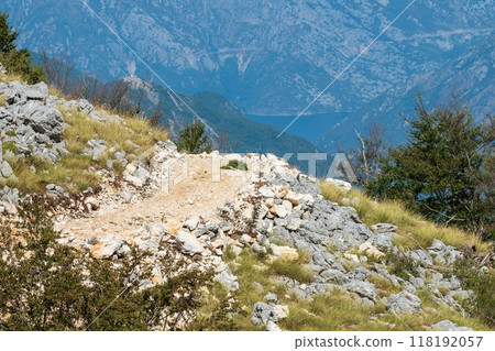 Rocky mountain path with distant valley view. Montenegro Rocky mountain path with distant valley view. Montenegro 118192057