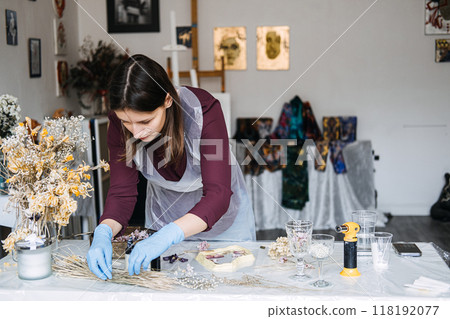 Woman crafting resin art in an artistic workspace for a small business. Creative entrepreneurship, DIY decor, handmade crafts, artisan studio, interior styling. Woman crafting resin art in an artistic workspace for a small business. Creative entrepreneurship, DIY decor, handmade crafts, artisan studio, interior styling. 118192077