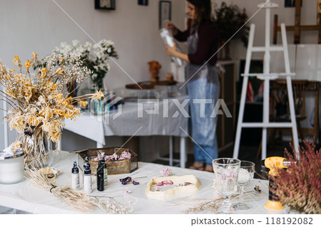 Artisan's workspace with dried flowers and resin crafting materials. Creative home decor, DIY projects, sustainable crafts, floral preservation, handmade art, eco-friendly workshop. Artisan's workspace with dried flowers and resin crafting materials. Creative home decor, DIY projects, sustainable crafts, floral preservation, handmade art, eco-friendly workshop. 118192082
